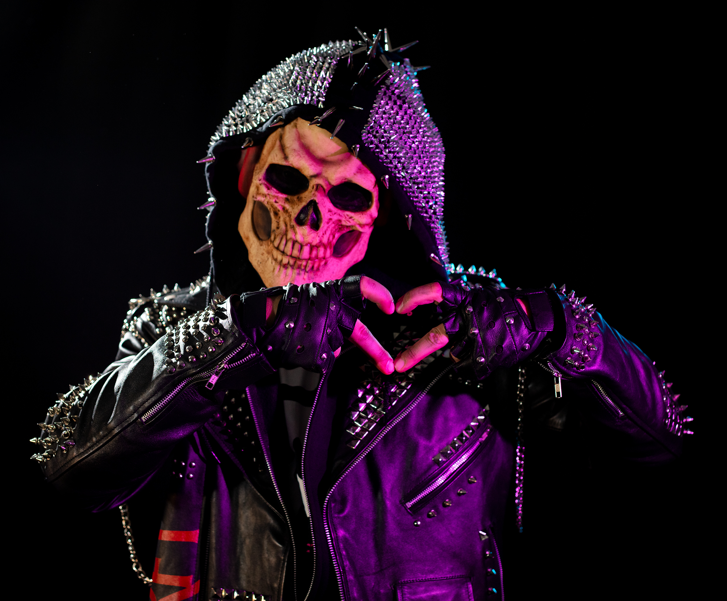 Skeleton Sam, a spiked leather-jacket-clad skeleton figure making a heart shape with his hands